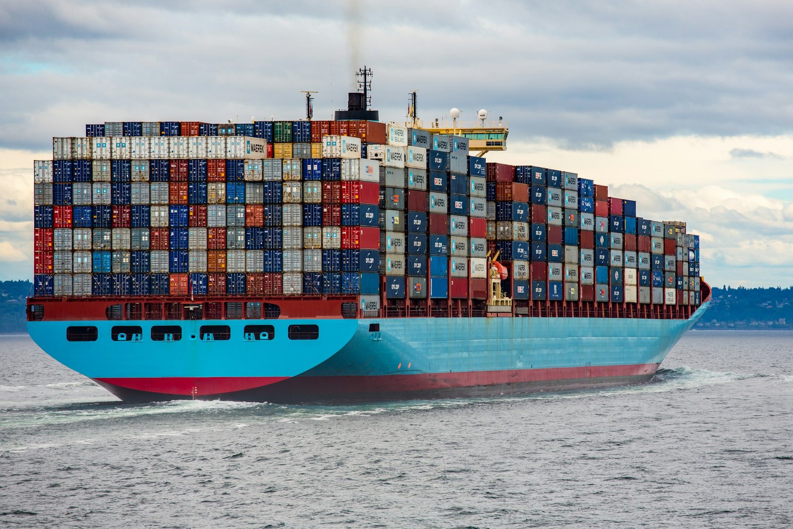 Container ship loaded at a port terminal with cranes