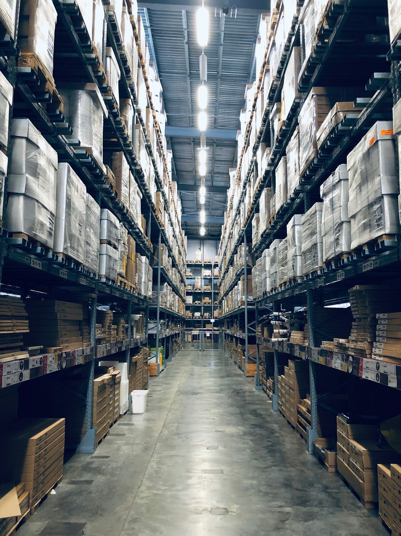 Warehouse aisle with tall pallet racking